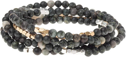 4.5 millimeter Kambaba Jasper beads interspersed with gold and silver beads wrapped four times to form a bracelet, shown on a white background.