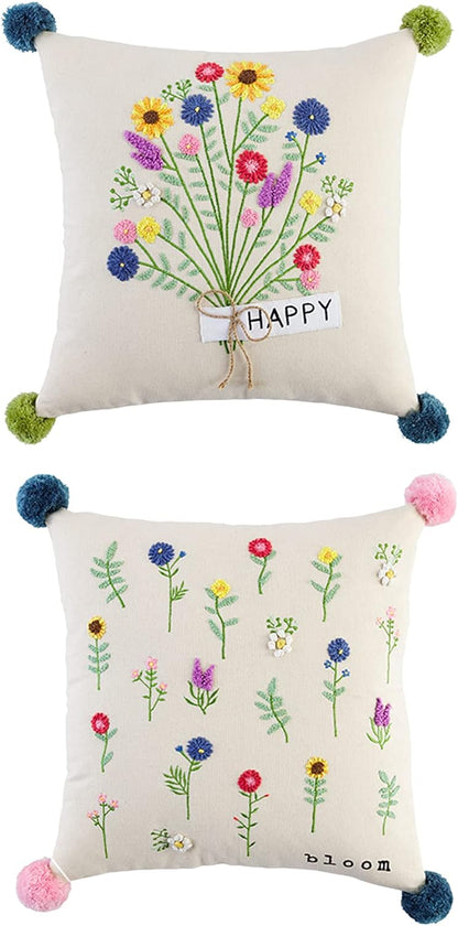 2 embroidered floral pillows on a white background.