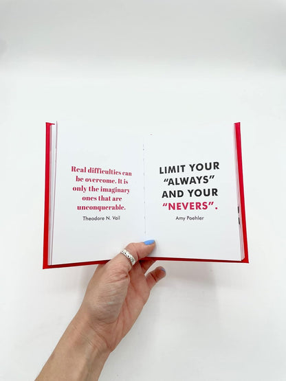 Hand holding an open book with more motivational quotes 
