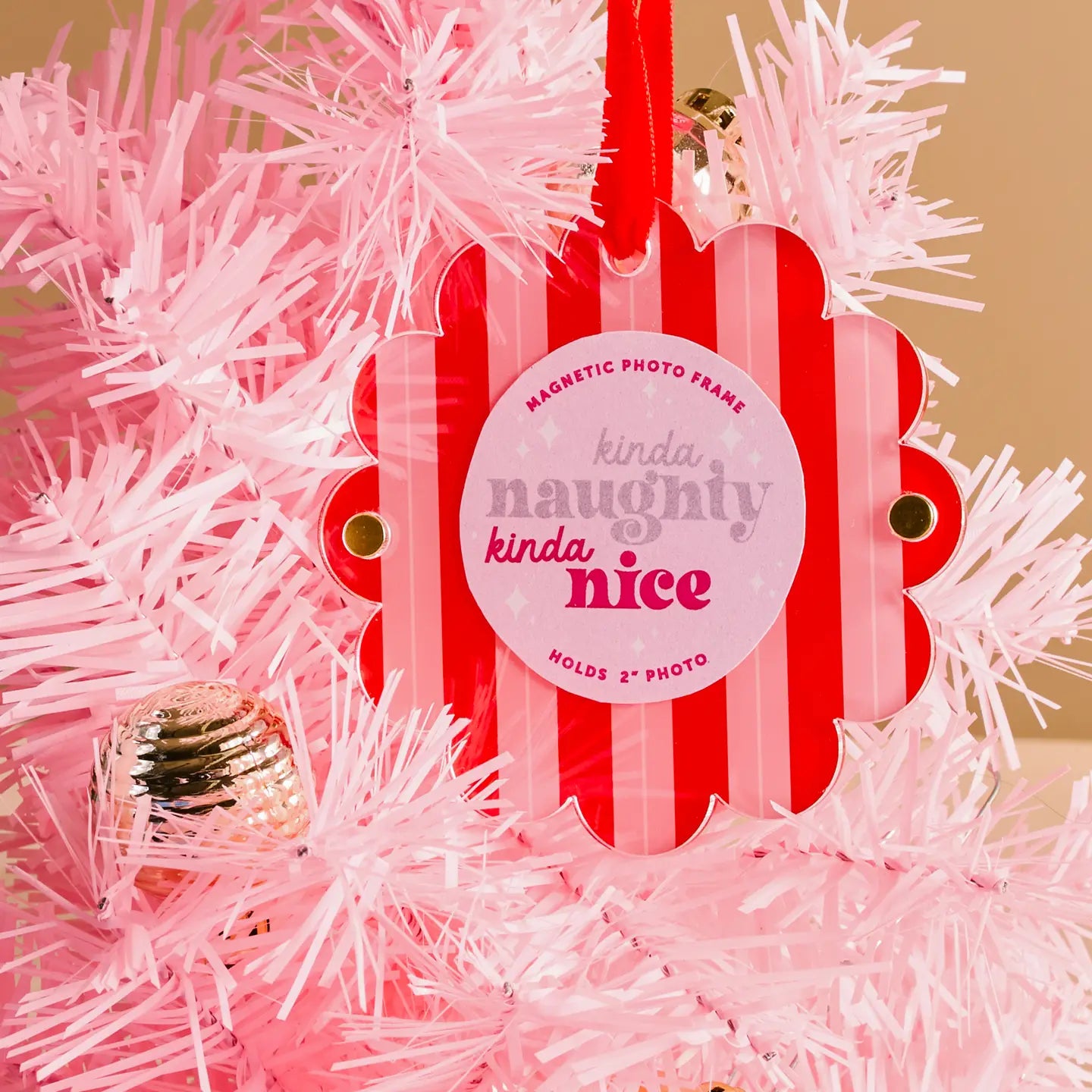 Red and pink striped photo frame with 'kinda naughty kinda nice' text on pink tinsel tree