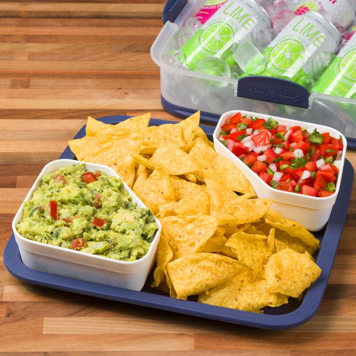 Party Carrier with guacamole in one corner bowl and salsa in another corner bowl and chips filling the middle