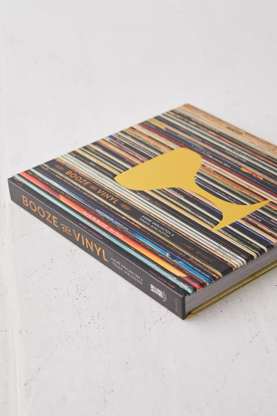side view of Booze & Vinyl book laying on a plaster surface