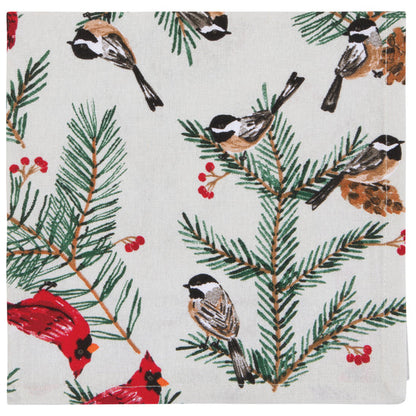 Festive patterned napkin with birds, pine branches, and red berries.