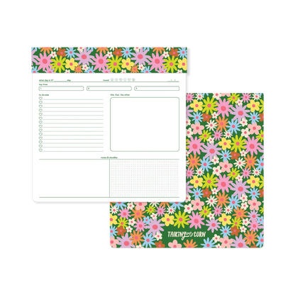 Floral patterned planner with a white section for writing on a white background