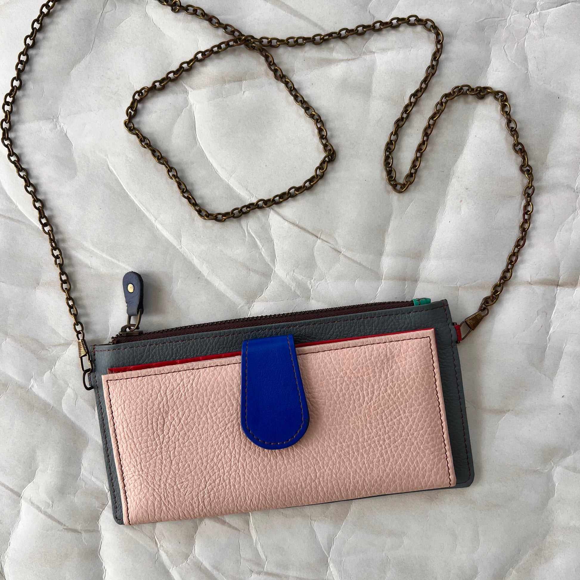 light pink kimber wallet with crossbody chain attached.