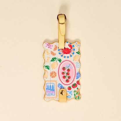 Decorative luggage tag with colorful designs on a beige background