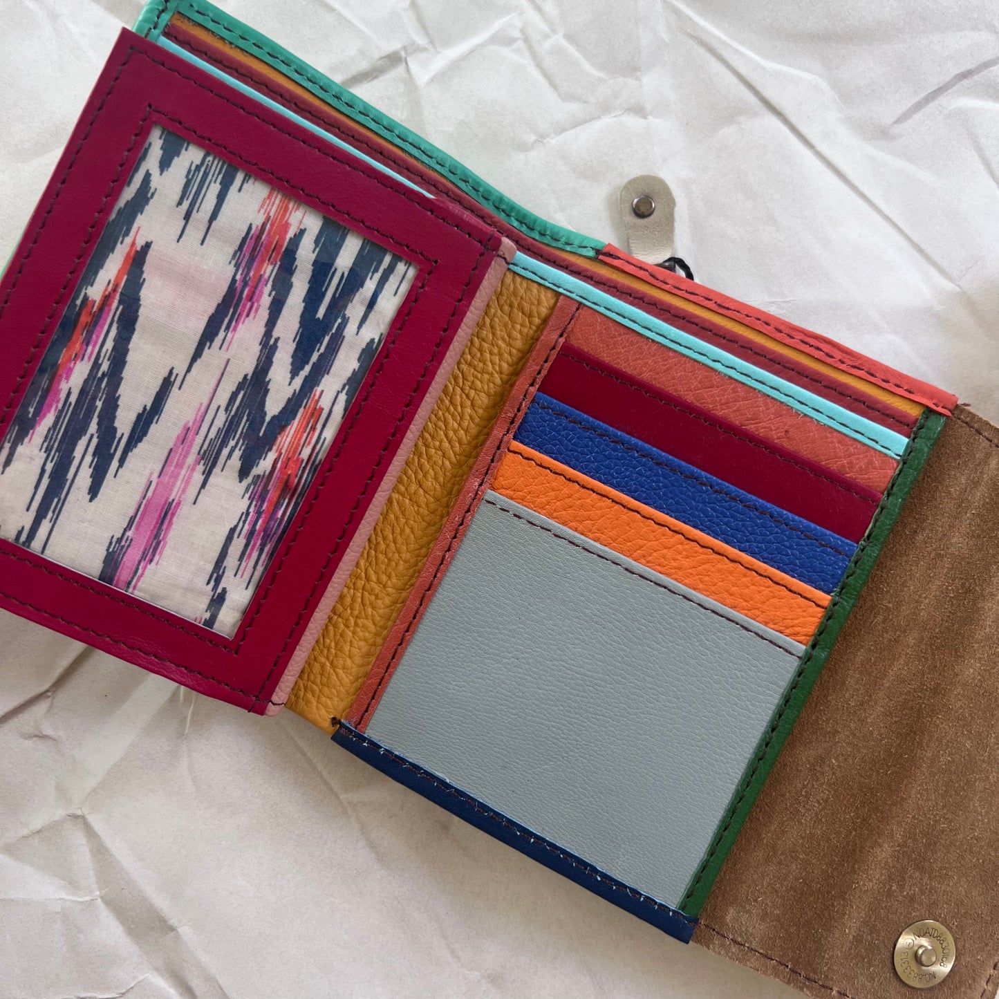 seafoam rings wallet laying flat showing colorful card slots