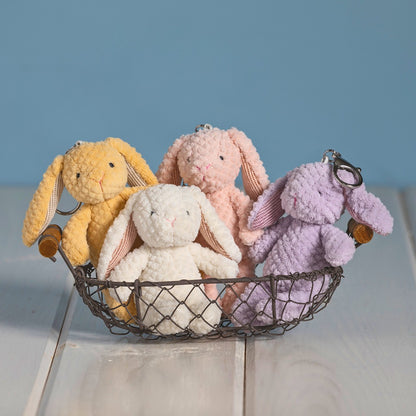basket with 4 bunny bag charms in 4 colors, orange, pink, cream, purple