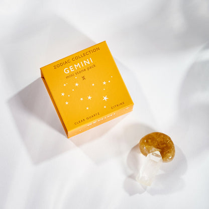 yellow gemini box with stone and crystal set next to it.