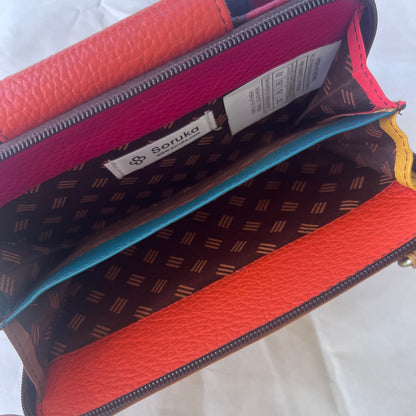 interior view of orange Beatrice Clutch zippered compartment