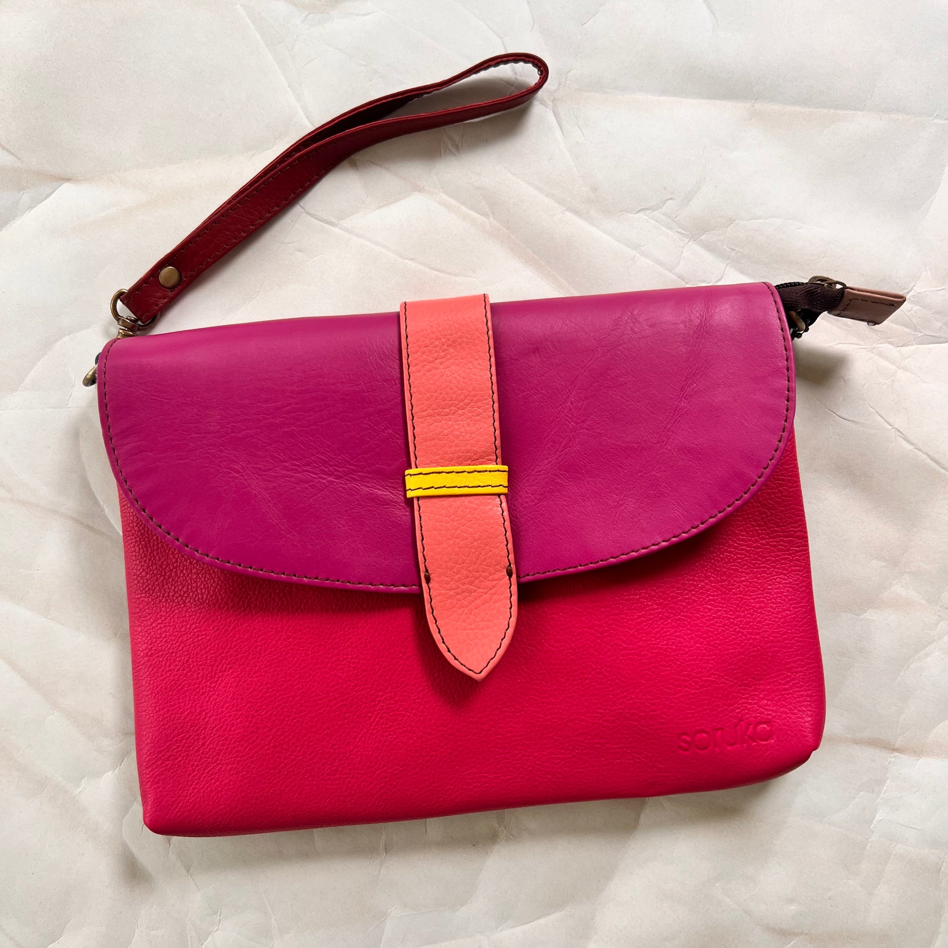 saddle bag with wristlet strap attached.