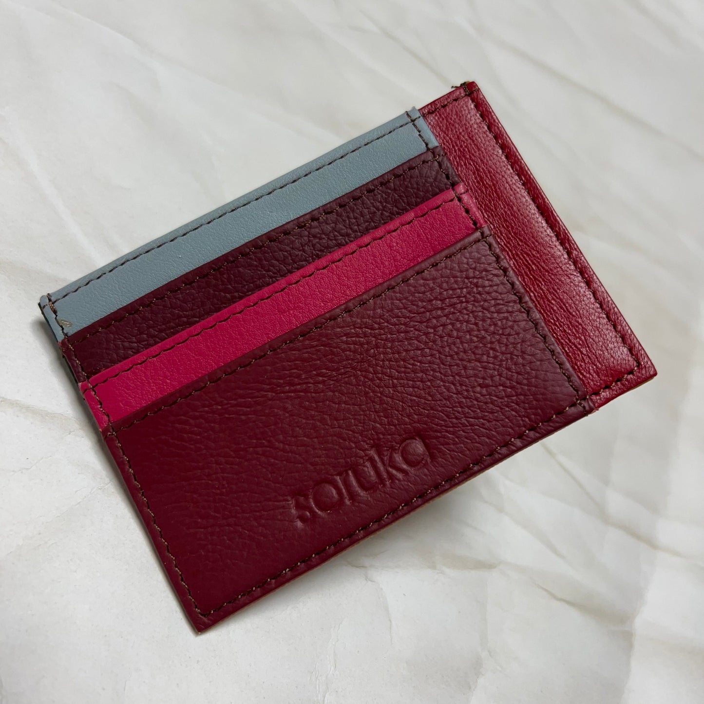 maroon polly wallet with colorful card slots.