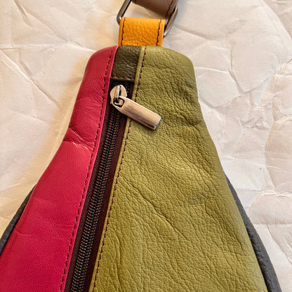 close-up of top of roxi sling bag showing zipper pull.