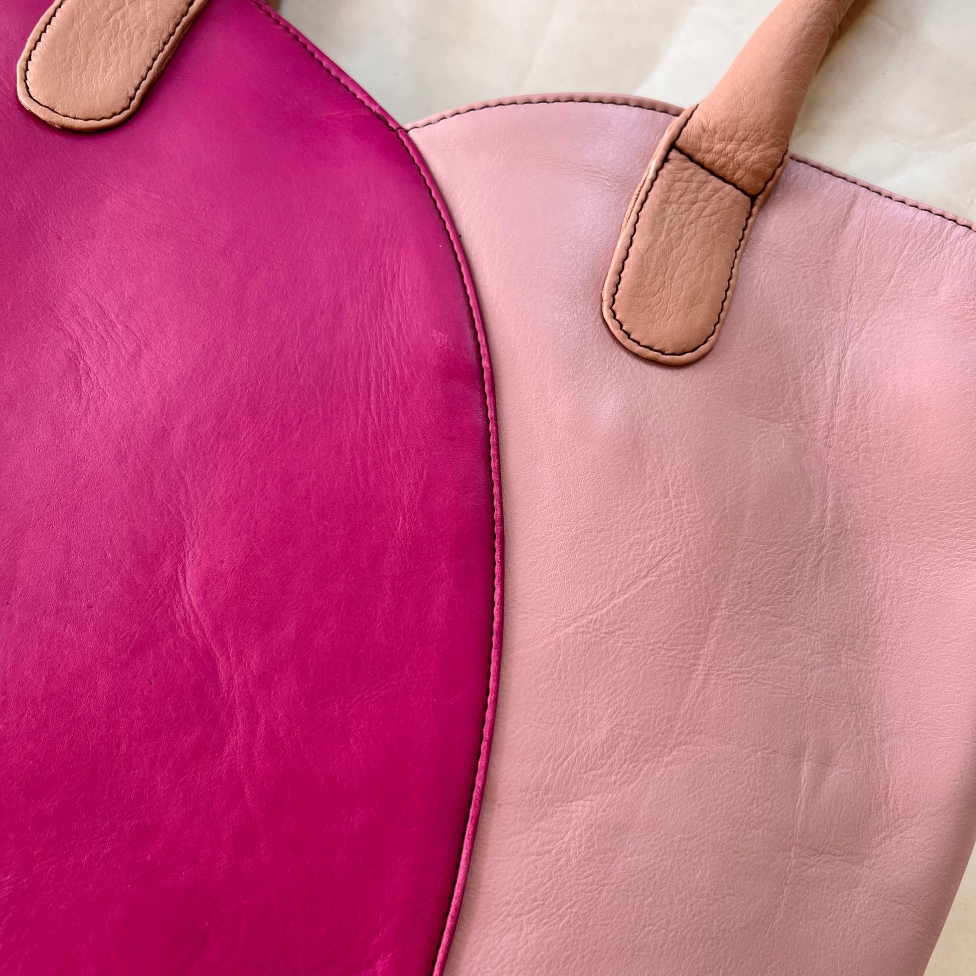 close-up of valeria tote that is half lilac and half bright pink with blush handles.