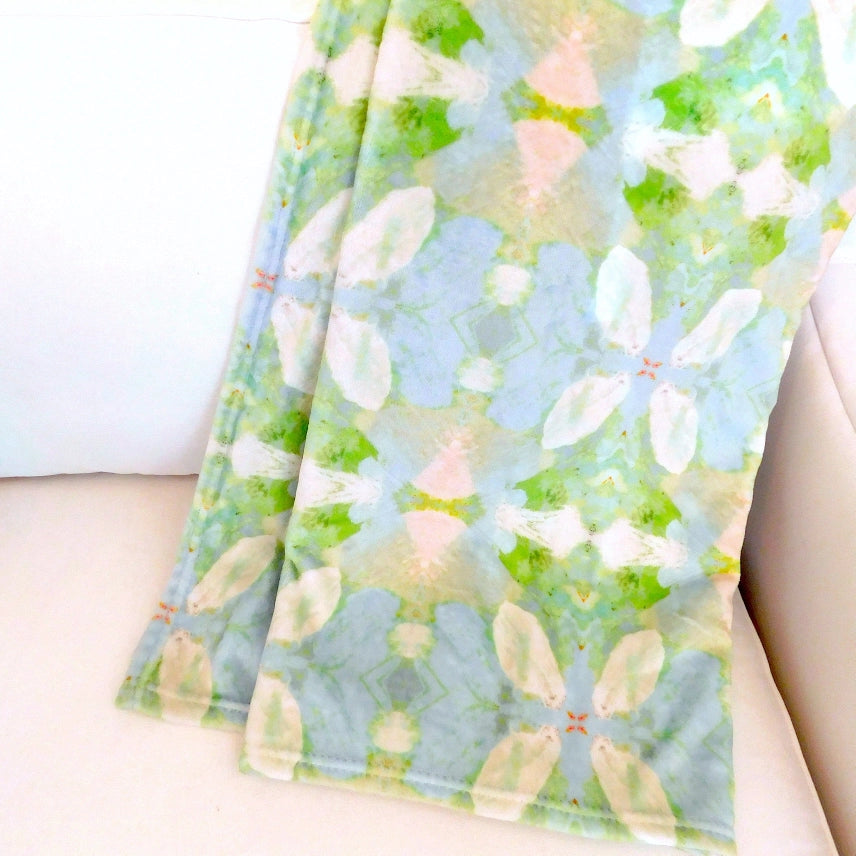 elephant falls fleece blanket draped over an arm chair