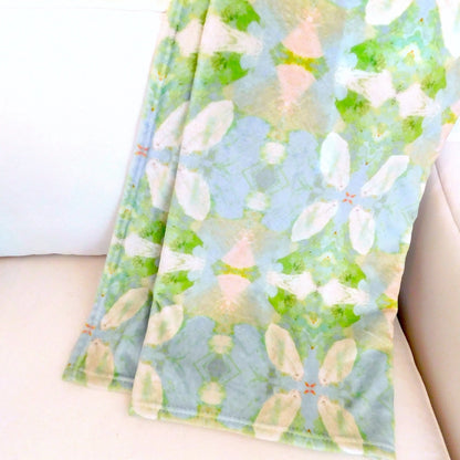 elephant falls fleece blanket draped over an arm chair