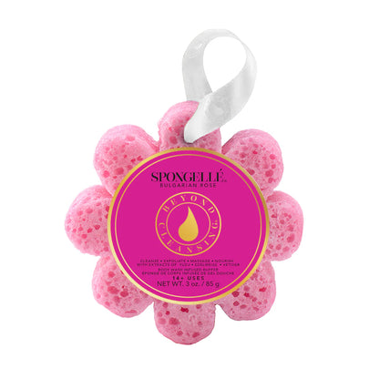 Pink flower-shaped sponge with a label on a white background