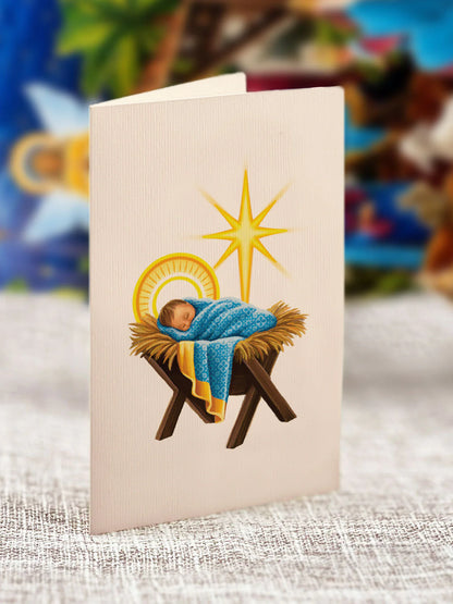 enclosure card of for Pop-Up Starlit Nativity printed with the image of baby Jesus laying in a manger.