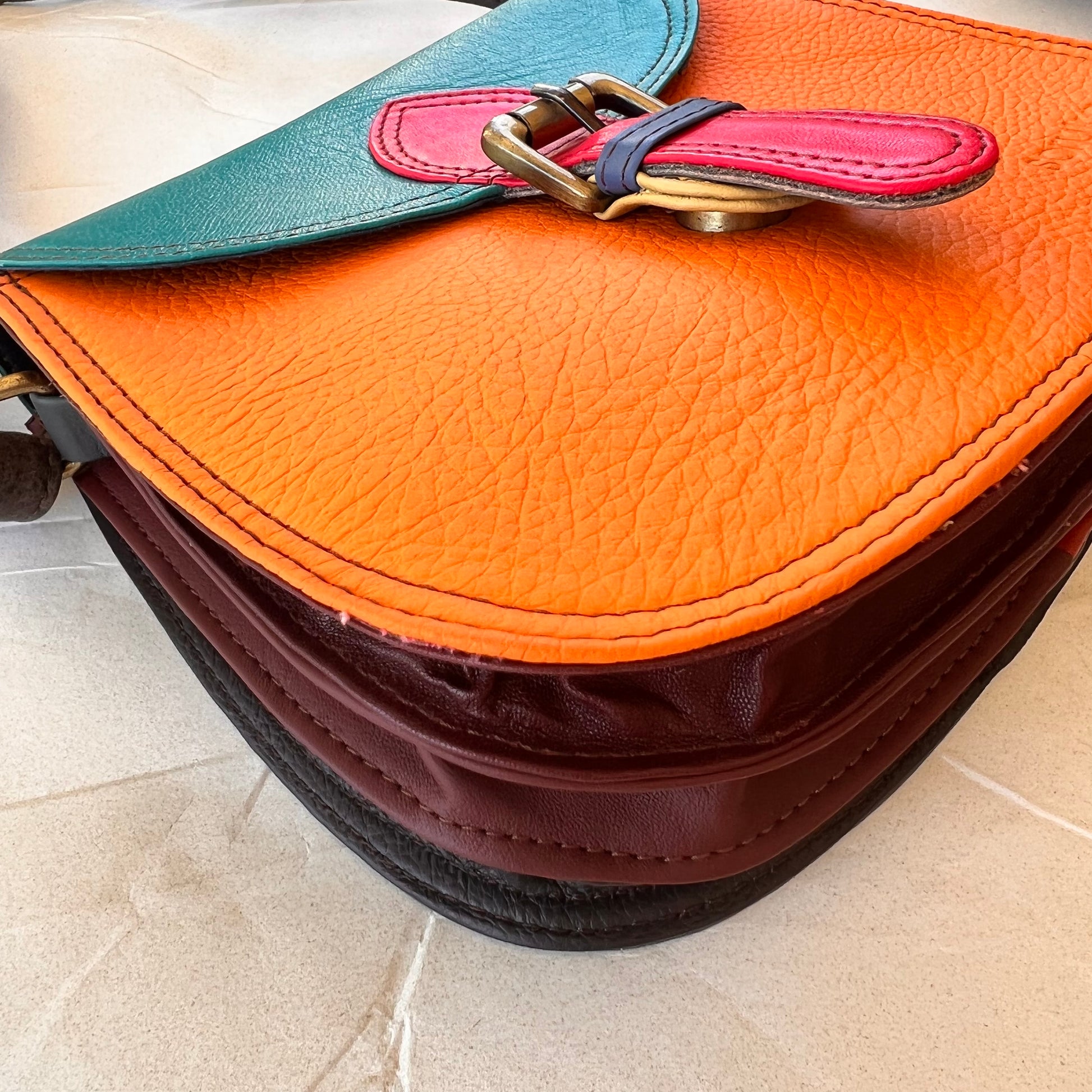 side view of Tangerine Ally bag showing three gussets.
