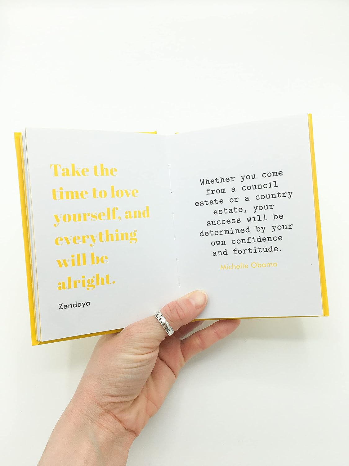 Open book with inspirational quote on a white background