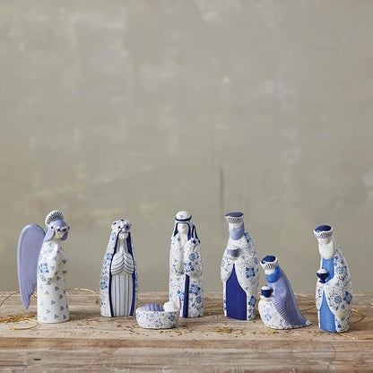 Blue & White Floral nativity set arranged on a table with gold ribbon
