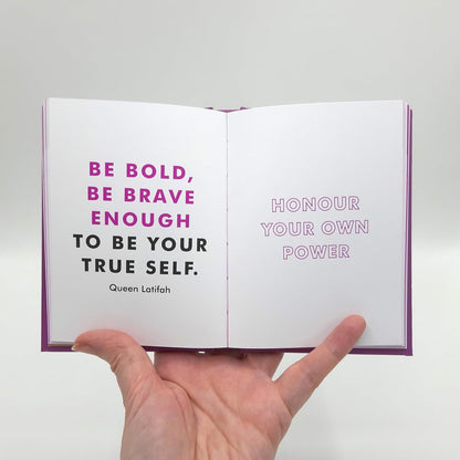 Open book with motivational quote on a white background