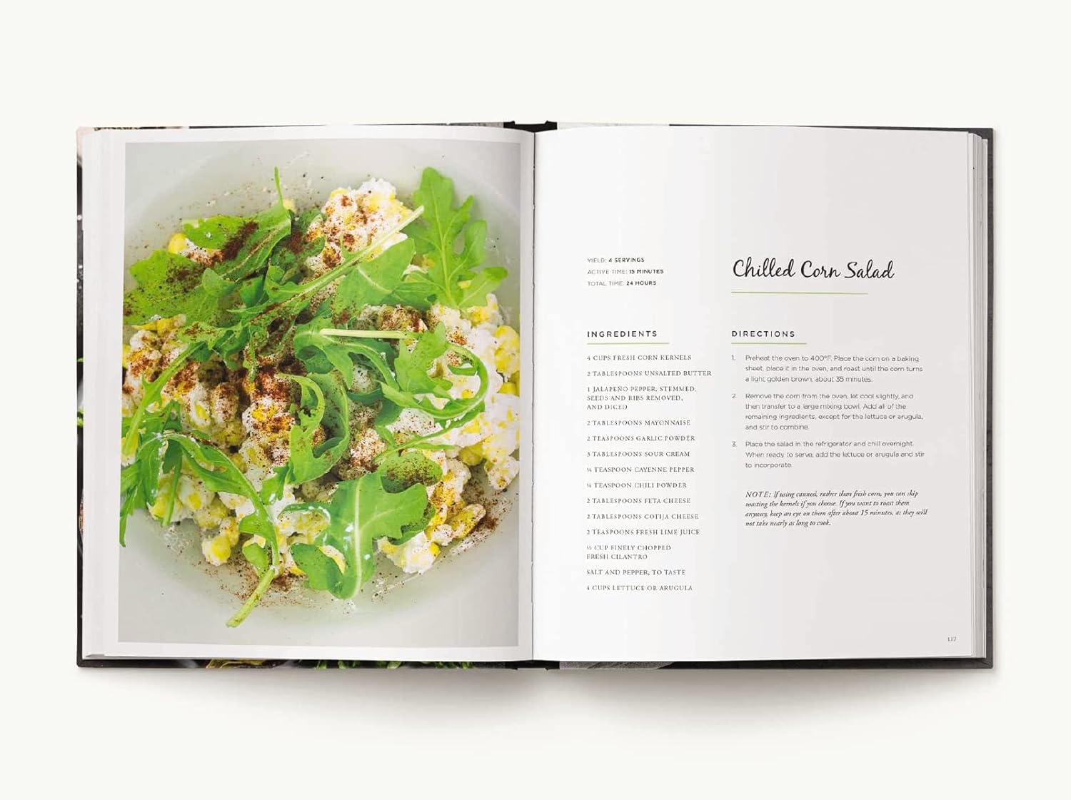 Open cookbook showing a page with a salad recipe and image of salad