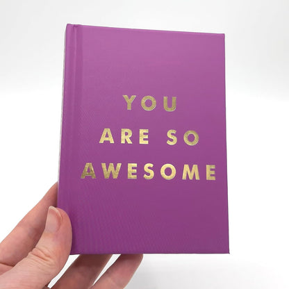 Purple book with 'YOU ARE SO AWESOME' text on a white background