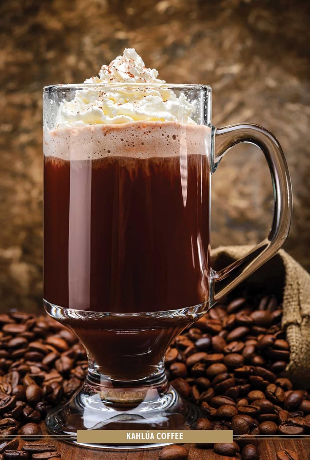 fancy coffee drink in glass mug topped with cream