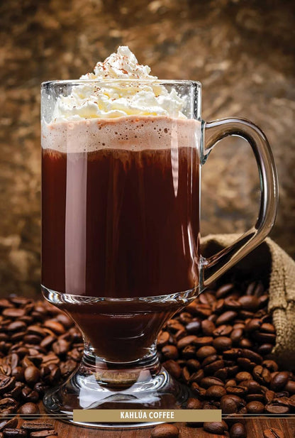 fancy coffee drink in glass mug topped with cream