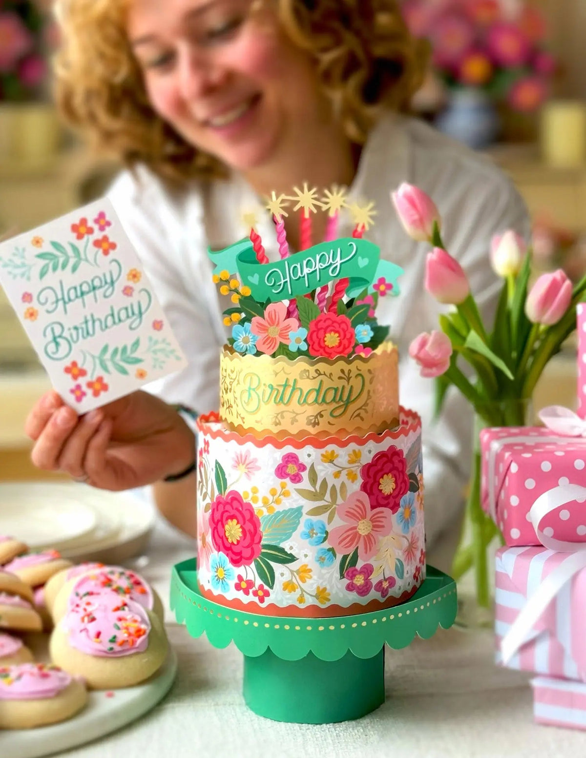 a person reading the note card for the Blooming Birthday Cake Pop-Up Bouquet