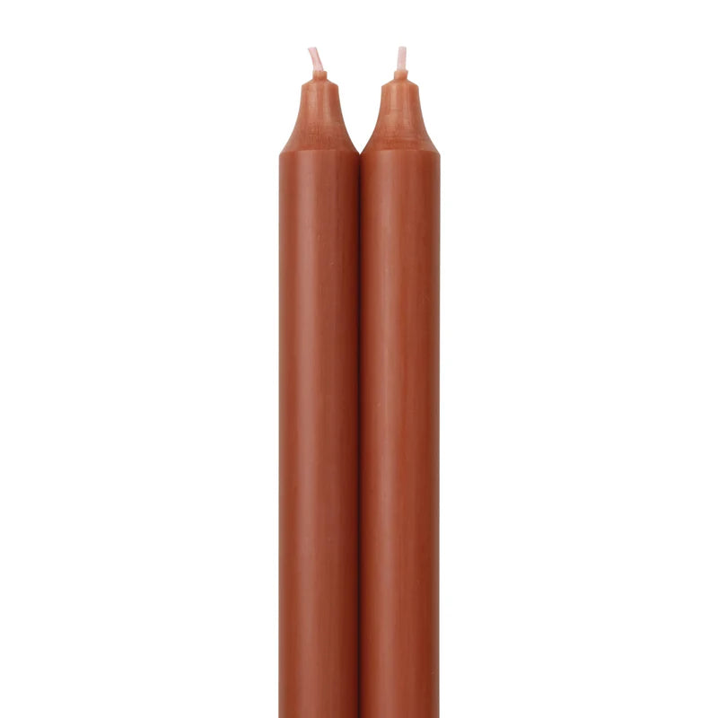 2 terracotta colored tapers on a white background.