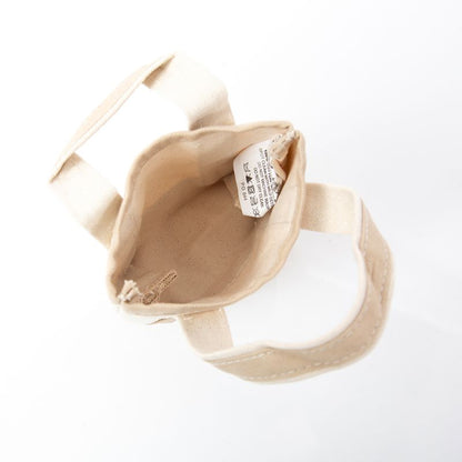 interior view of off white mini tote bag with pale pink handles and trim