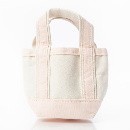 off white mini tote bag with pale pink handles and trim
