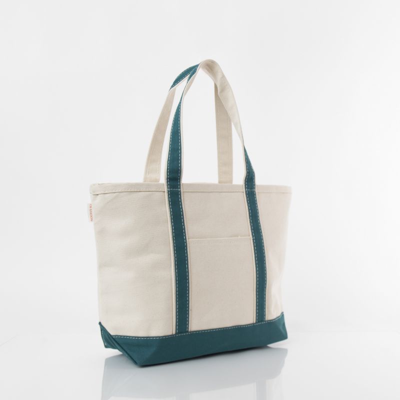 angled view of off white tote with teal green trim and handles