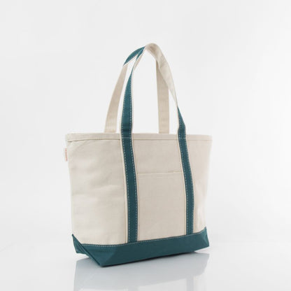 angled view of off white tote with teal green trim and handles