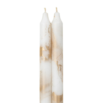 2 pure white and gold marbled taper candles next to each other