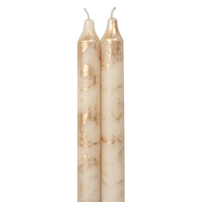 2 cream colored tapers  with gold swirls on a white background.