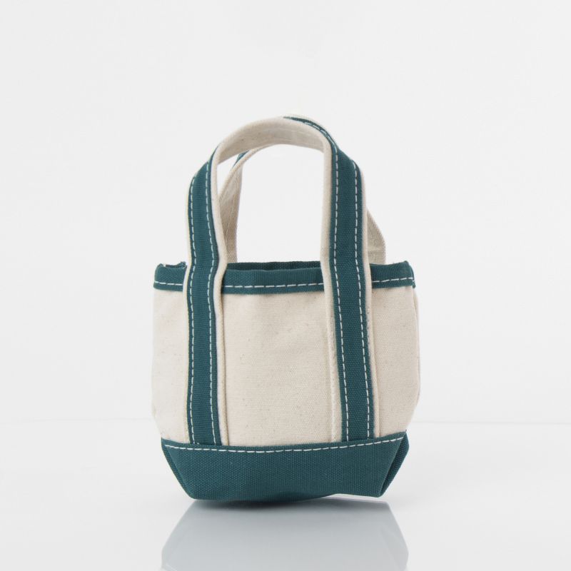 off white mini tote bag with teal green handles and trim