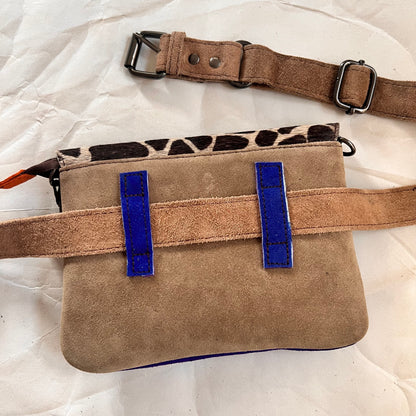 solid taupe back of bag with blue loops holding brown belt.