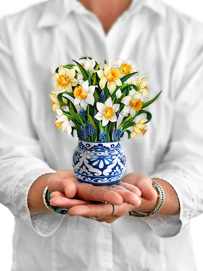 person holding English Daffodils pop-up bouquet in front of them.
