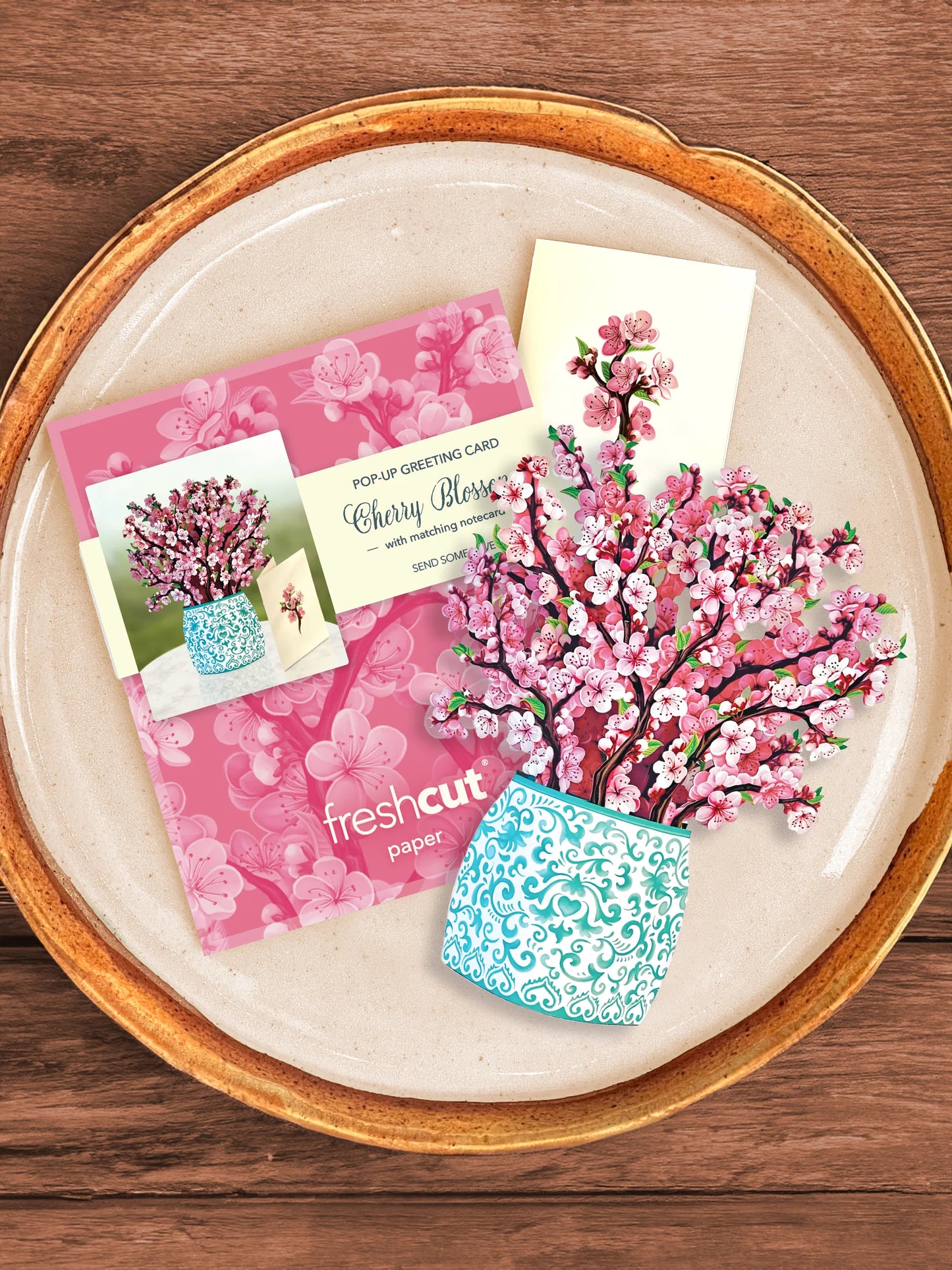 Cherry Blossom bouquet, enclosure card, and mailing envelope arranged on a tray.