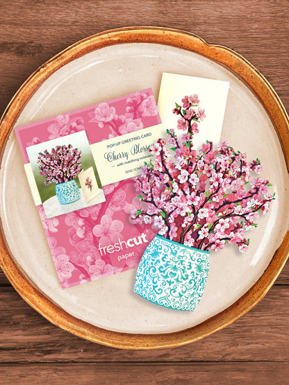 Cherry Blossom bouquet, enclosure card, and mailing envelope arranged on a tray.