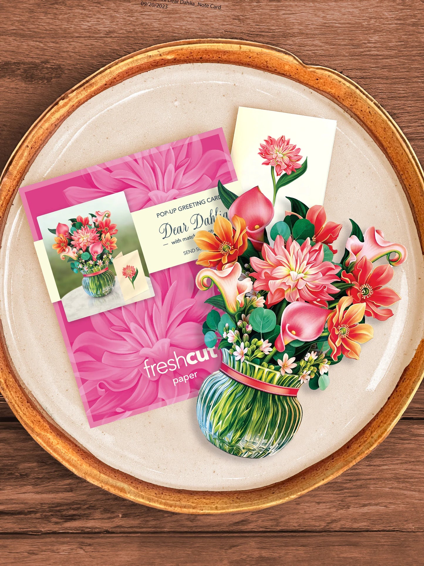Dear Dahlia bouquet, enclosure card, and mailing envelope arranged on a tray.