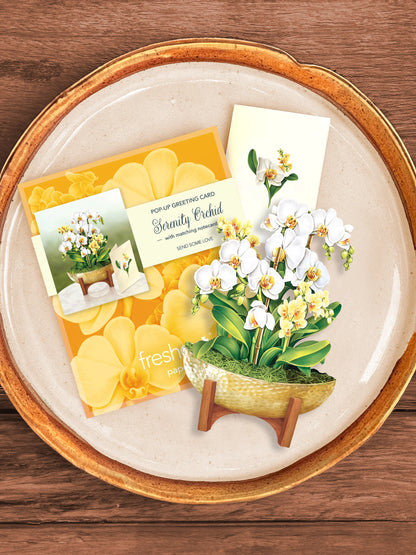 Serenity Orchid bouquet, enclosure card, and mailing envelope arranged on a tray.
