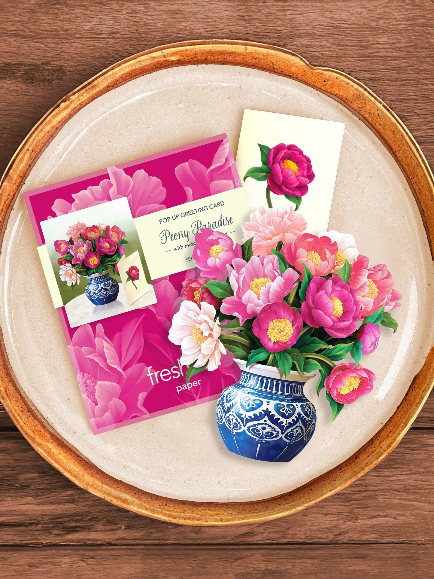 Peony Paradise bouquet, enclosure card, and mailing envelope arranged on a tray.