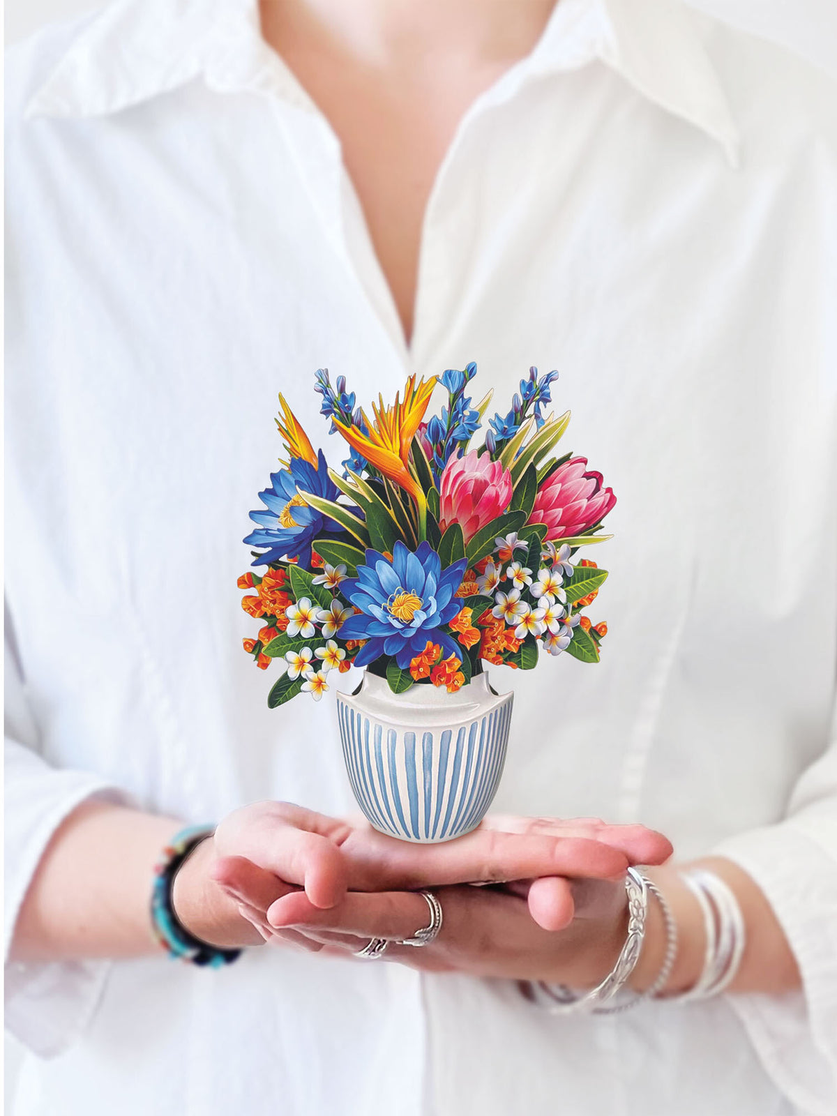 a person holding the mini tropical paradise pop up card