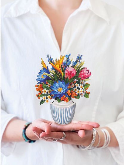 a person holding the mini tropical paradise pop up card