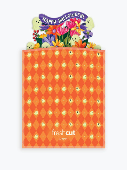 An orange Halloween-themed greeting card envelope with a diamond pattern and a colorful pop-up 'Happy Halloween!' floral and ghost card coming out of it