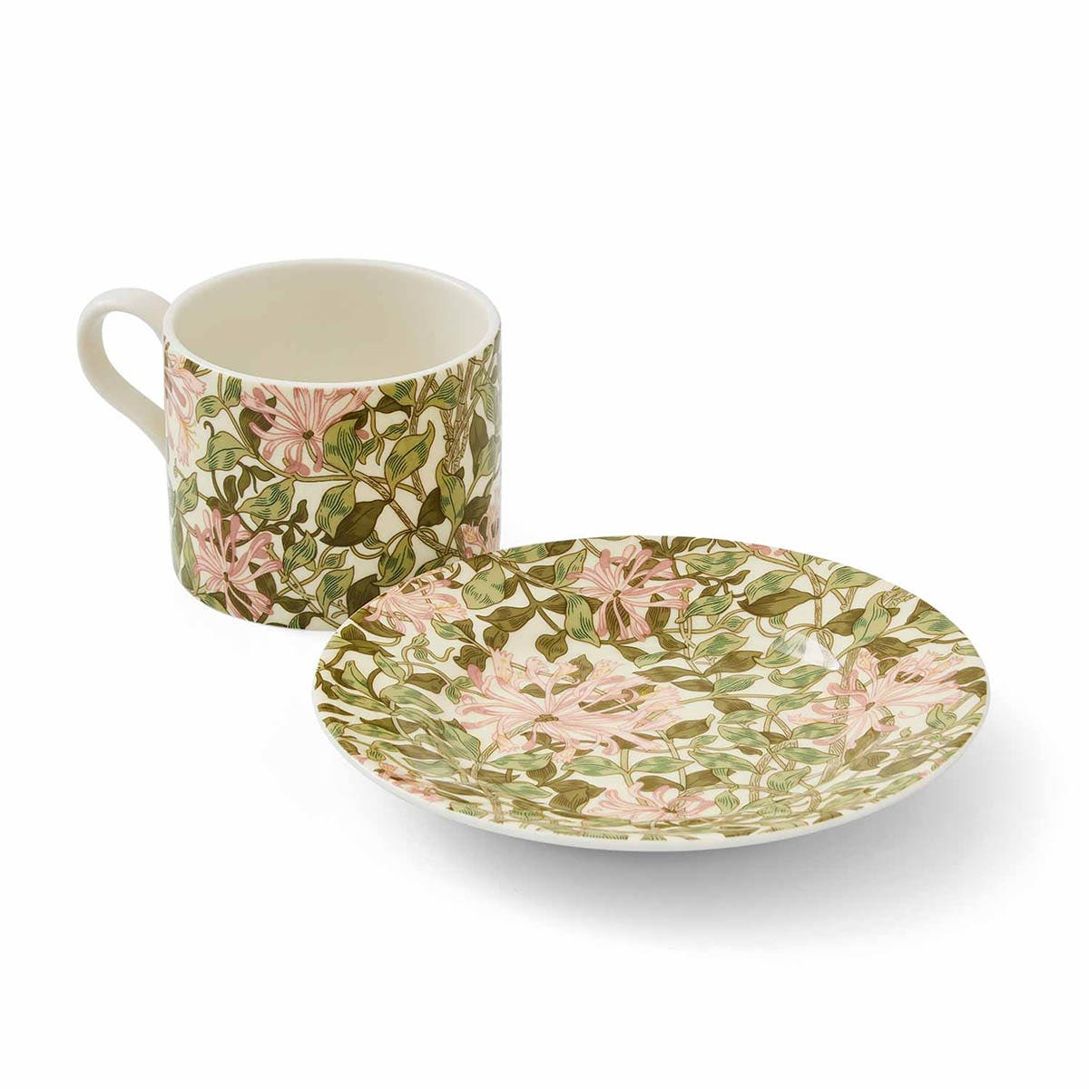 honeysuckle teacup next to the saucer on a white background